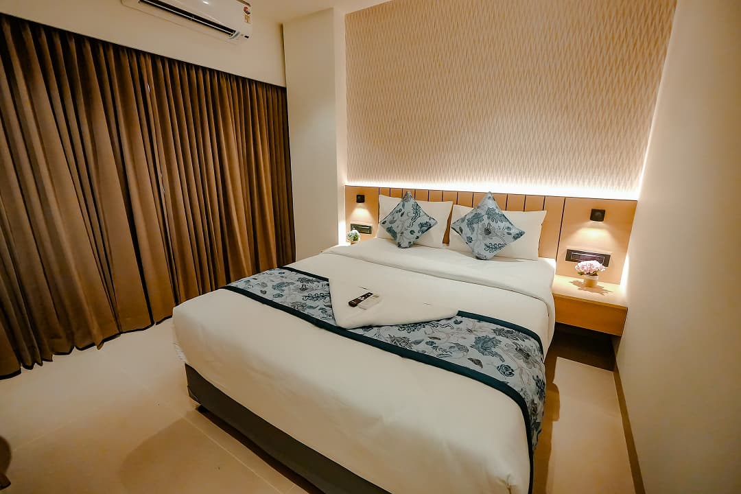 Bedroom sideview of Premium double room at BKS Grand Hotel, Kodigehalli, Bengaluru
