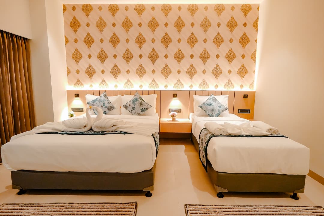 Bedroom frontview of Premium triple room at BKS Grand Hotel, Kodigehalli, Bengaluru