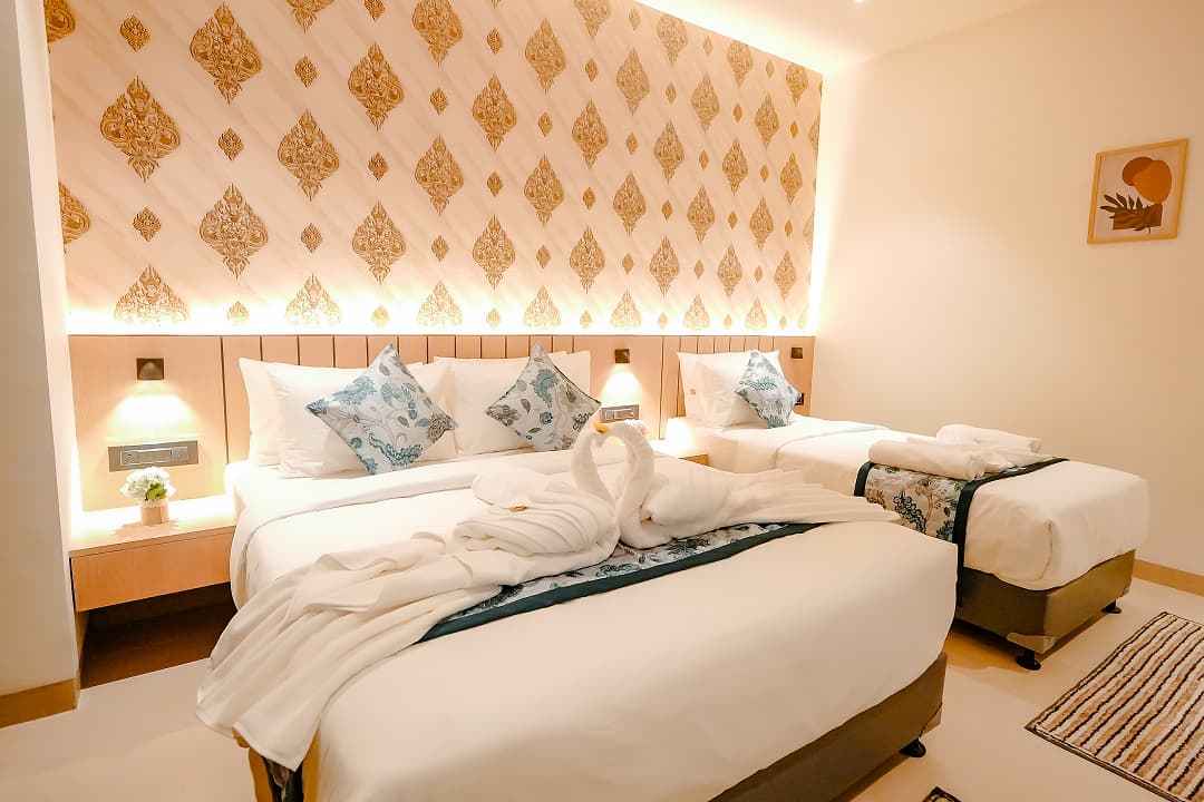 Bedroom sideview of Premium triple room at BKS Grand Hotel, Kodigehalli, Bengaluru