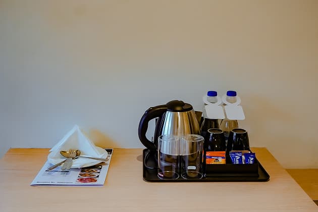 Room amenities including kettle, coffee and sugar sachets at BKS Grand Hotel